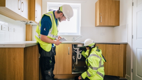 LiveWest colleagues working on a kitchen in a home. 