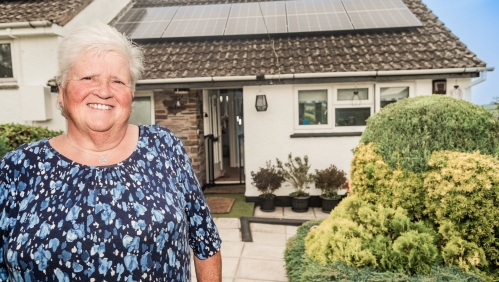 Carol Harris outside her home with new solar panels