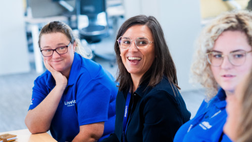 Emma Jones (middle) smiling alongside her colleagues. 