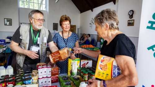 Volunteers serving a customer at Holsworthy Food Hub.