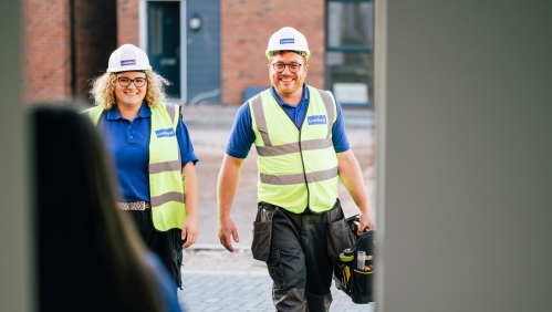 Jamie Sperring and a colleague walking towards a customer's home.