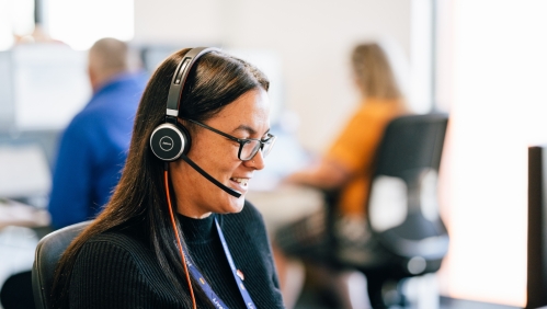 LiveWest colleague speaking on the phone using a headset. 