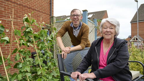 Image of two LiveWest customers smiling in their garden