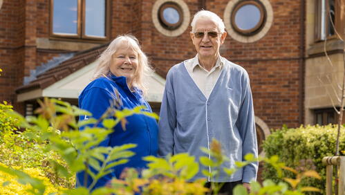 Image of a LiveWest colleague and customer stood outside in a garden smiling.