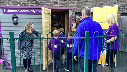 Image of LiveWest colleagues and children entering the community larder