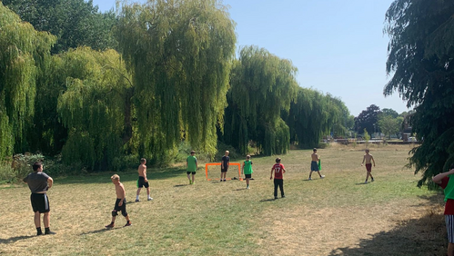 Image of young people playing ball games on a field in one of the 'summer sessions' in Bridgwater