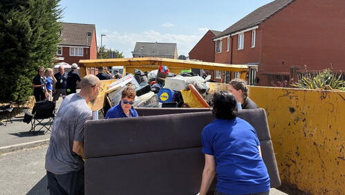 LiveWest residents and colleagues carrying bulky waste to skips