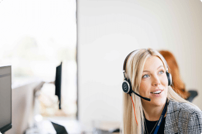 LiveWest colleague working in a LiveWest office communicating with a customer through headset.