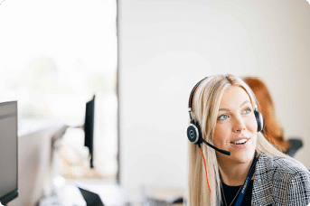 LiveWest colleague working in a LiveWest office communicating with a customer through headset.