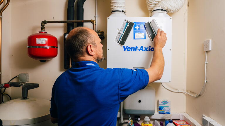 LiveWest colleague working on a boiler.