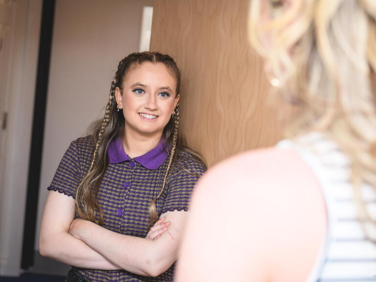 Resident Amiee stood chatting to a colleague. Photo: LiveWest